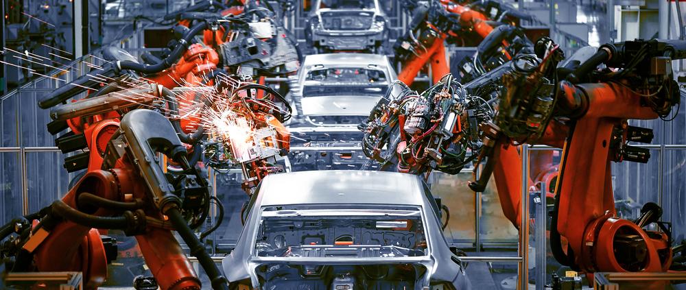 Automobile factory showing assembly line with welding robots