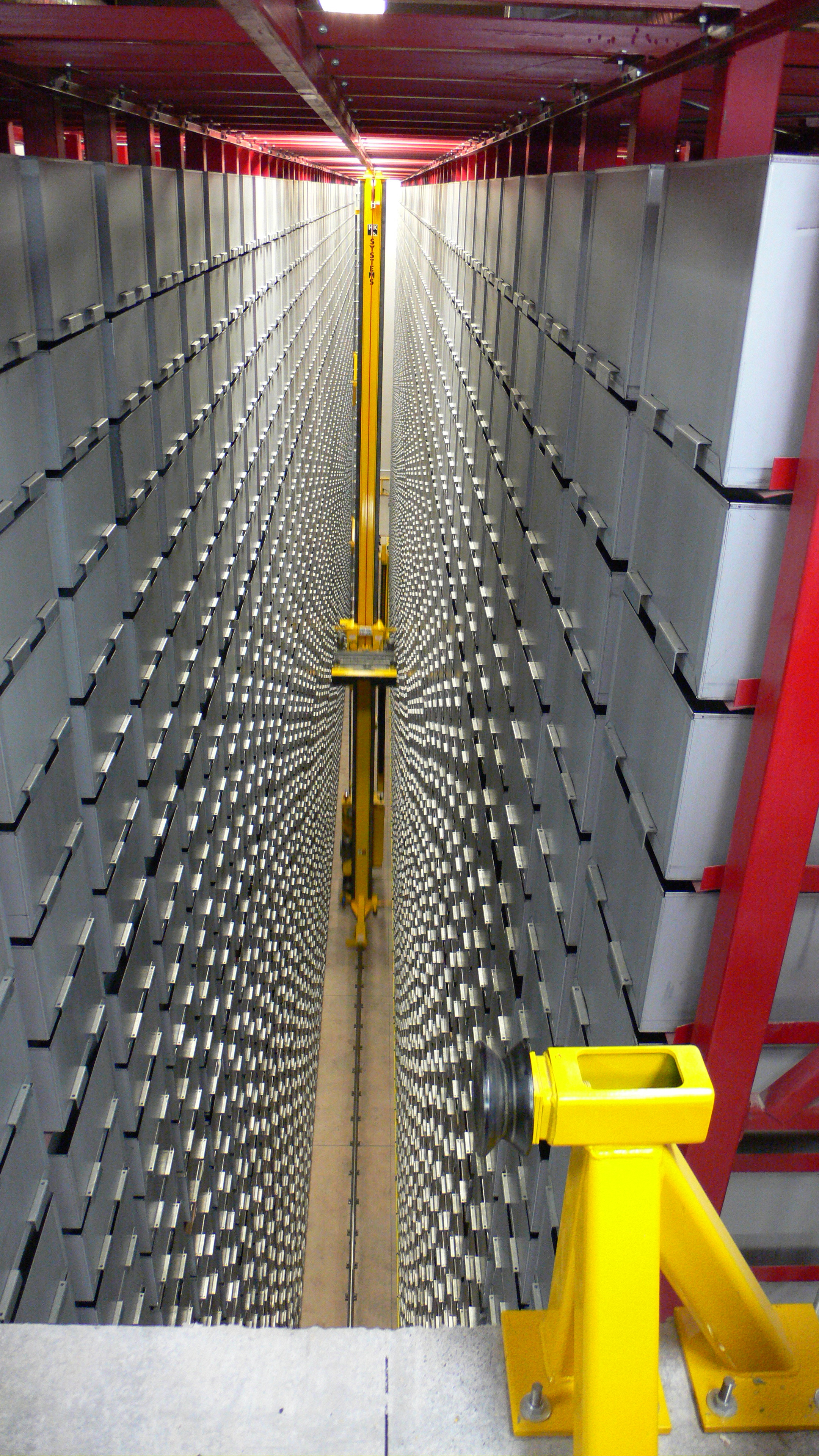 An automated storage and retrieval system fetching books in a library.